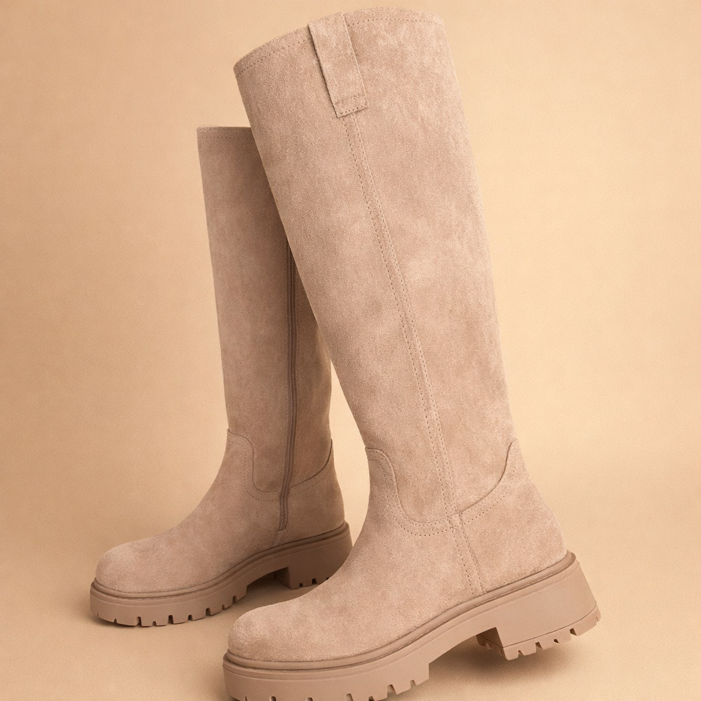beige-knee-high-boots-studio-pose-caramel-sand-background.png