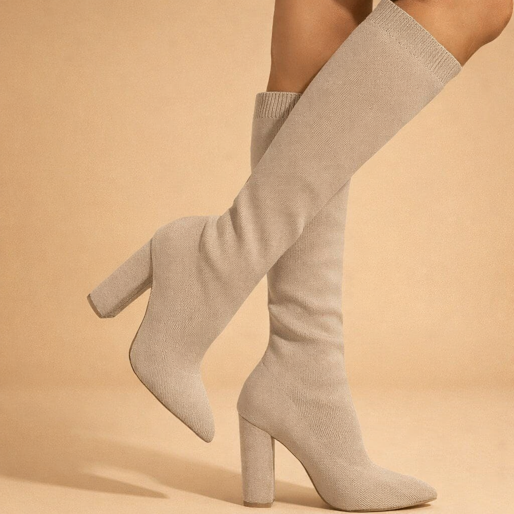 beige-knee-high-knit-sock-boots-block-heel-pointed-toe-model-pose-studio-sho.png