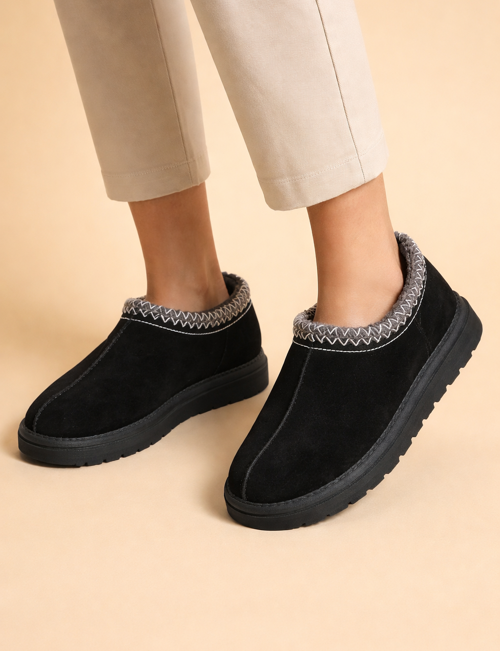 black-suede-womens-slip-on-moccasin-slippers-faux-fur-trim-european-studio-model-pose.png