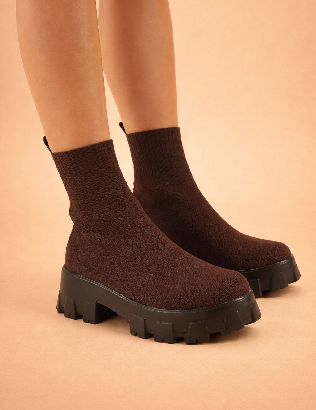 european-model-wearing-chocolate-brown-chunky-sole-knit-ankle-boots-studio-pose.png