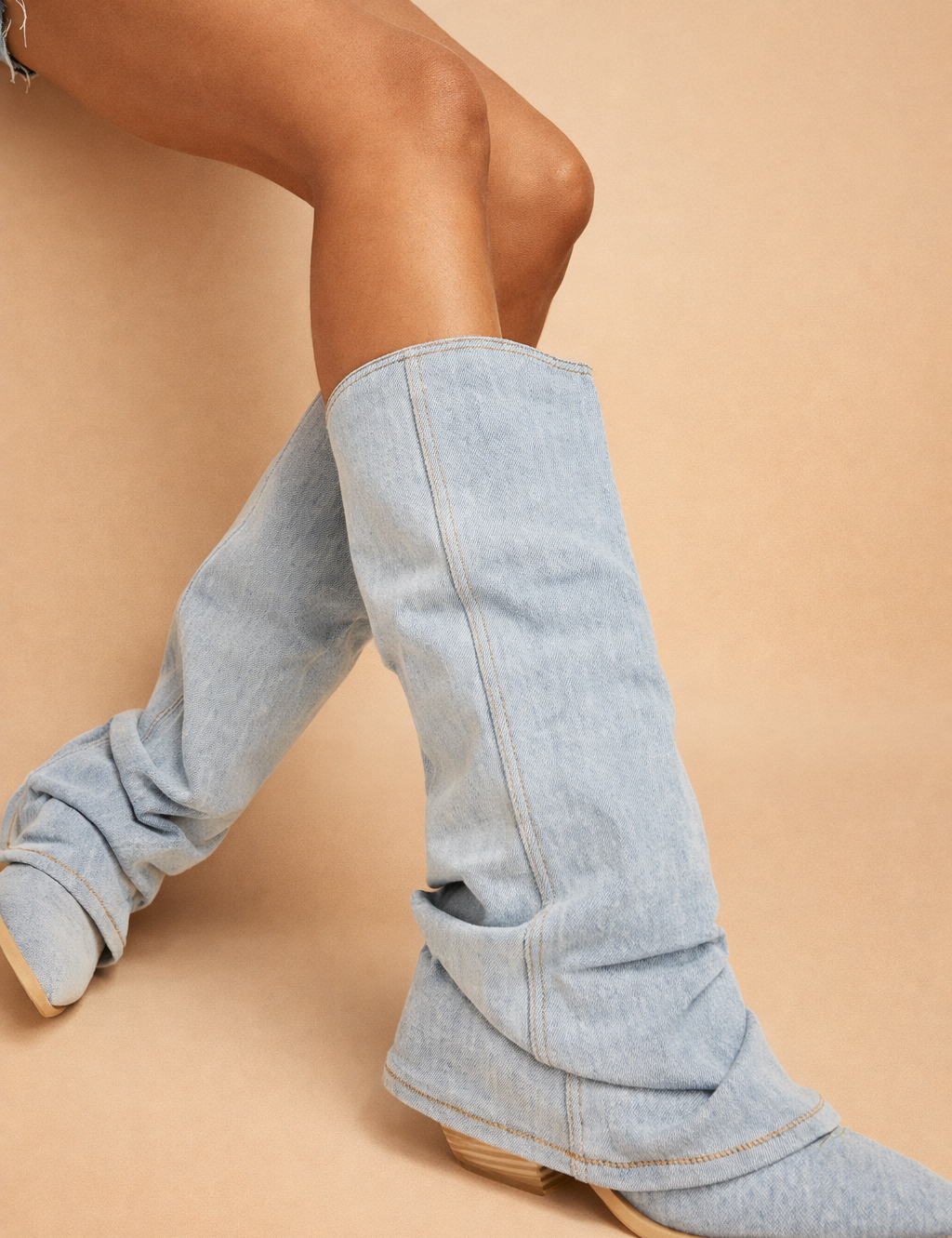 light-denim-slouchy-knee-high-boots-european-model-studio-pose-side-view_9c41d025-b99c-4244-aeda-c3072d96ae90.png