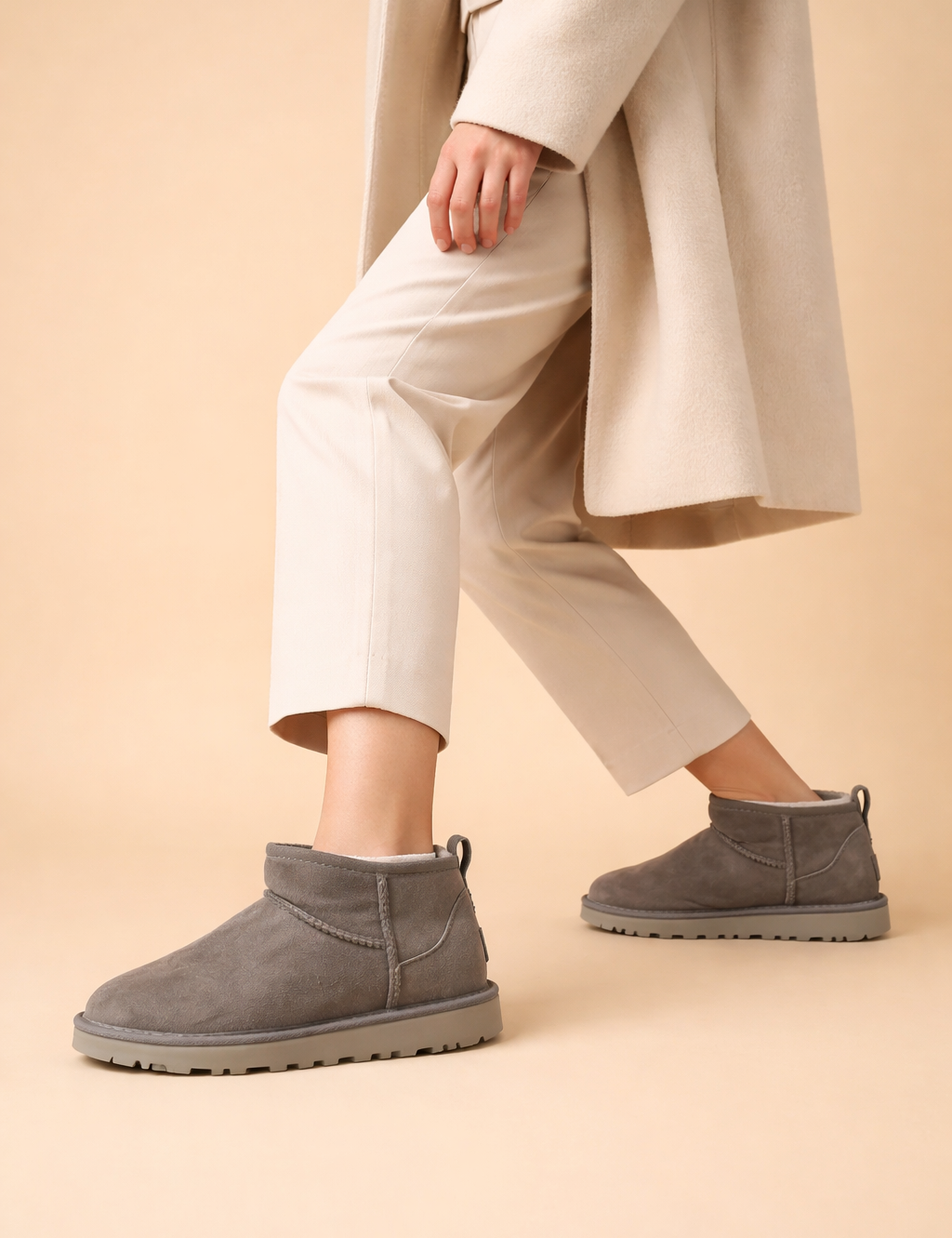 polish-grey-suede-ankle-boots-warm-sand-studio-posed-step-forward-view.png
